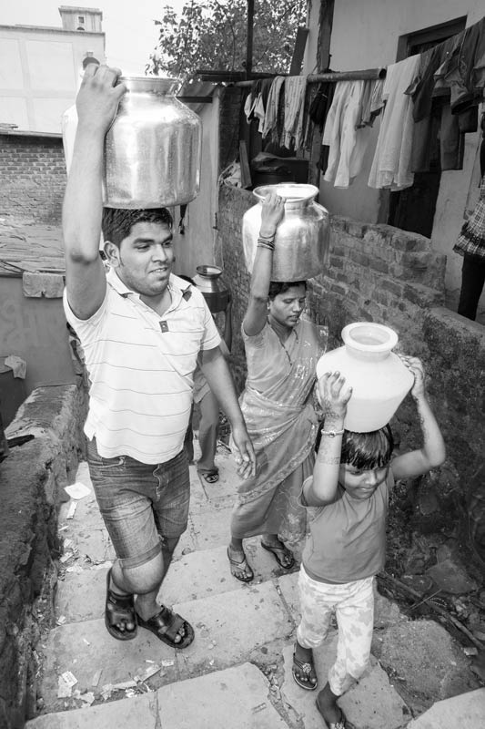 Water portraits - A moment of joy getting water from a public standpoint where the number of standpoints is few against hundreds and thousands of population and water supply is irregular - Mumbai city, Maharashtra